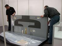 Brunel exhibition being set up. At least two people are needed to construct it.