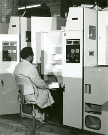Postal worker sat in front of a new electronic coding desk, 1970s